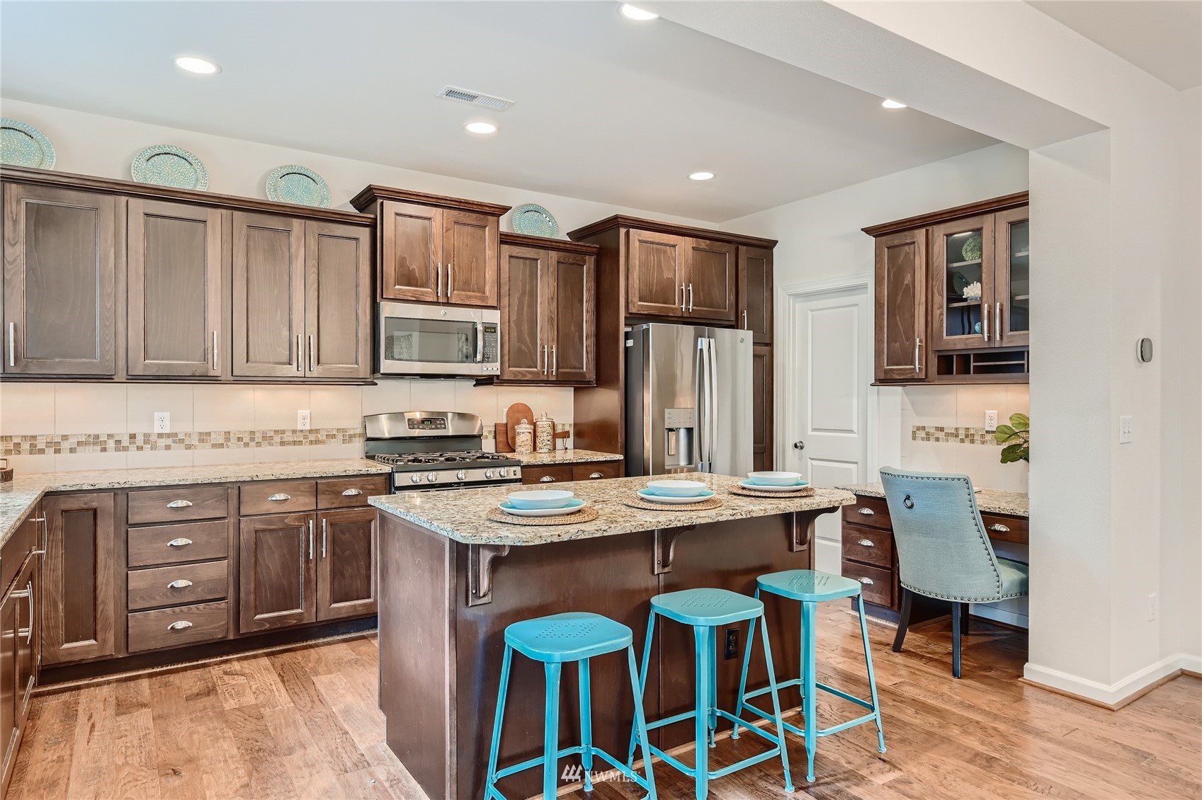 3532 198th Street Southeast Bothell, WA 98012 - Photo 12 of 39 a kitchen with stainless steel appliances granite countertop a stove a sink a microwave a refrigerator and cabinets