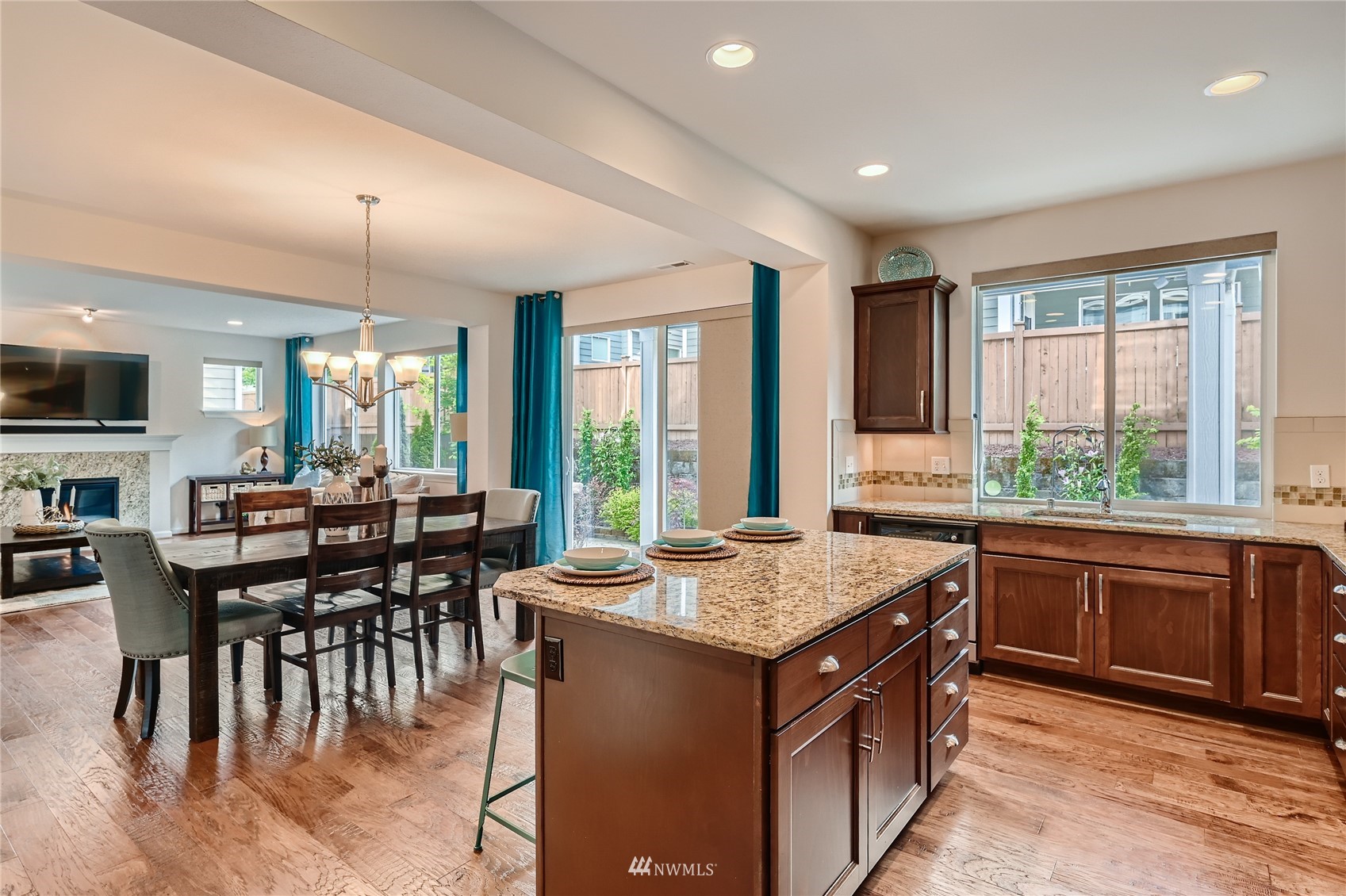 3532 198th Street Southeast Bothell, WA 98012 - Photo 15 of 39 a kitchen with a stove a sink a dining table and chairs