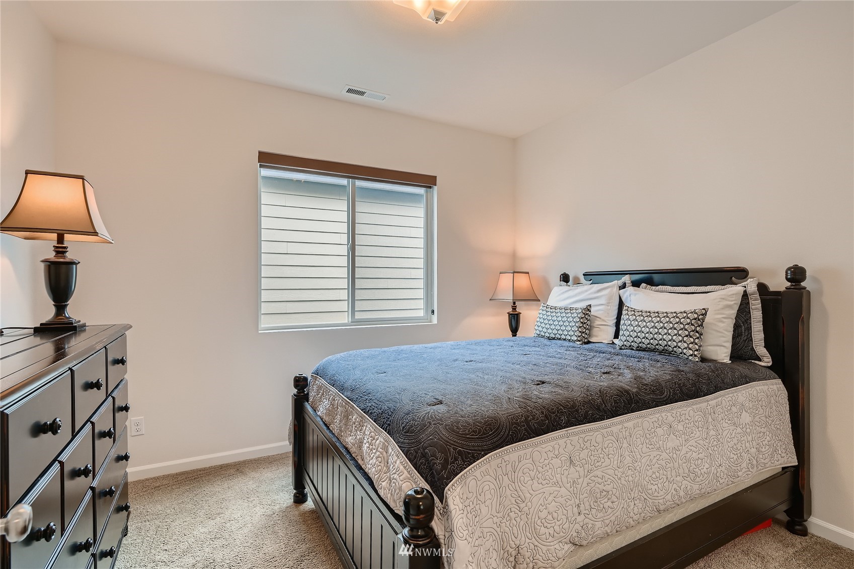 3532 198th Street Southeast Bothell, WA 98012 - Photo 29 of 39 a bedroom with a bed a lamp and a window