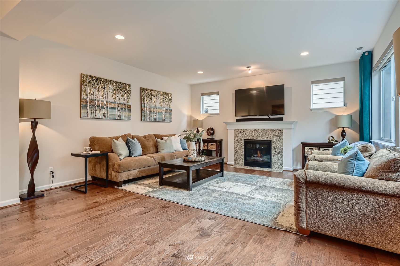 3532 198th Street Southeast Bothell, WA 98012 - Photo 6 of 39 a living room with furniture a flat screen tv and a fireplace