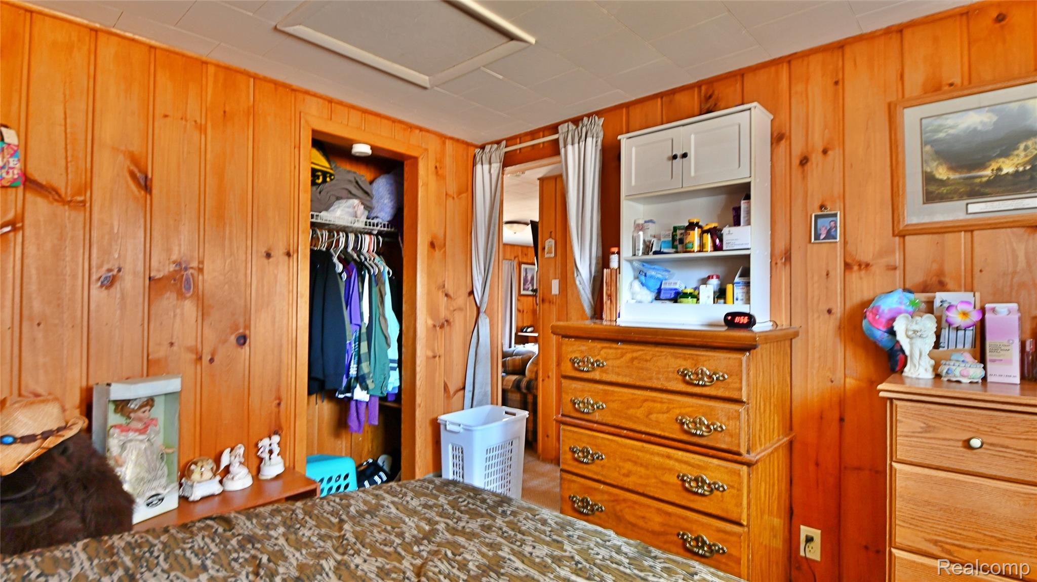 10456 Austin Road St. Helen, MI 48656 - Photo 16 of 24 Bedroom with knotty pine walls and a closet
