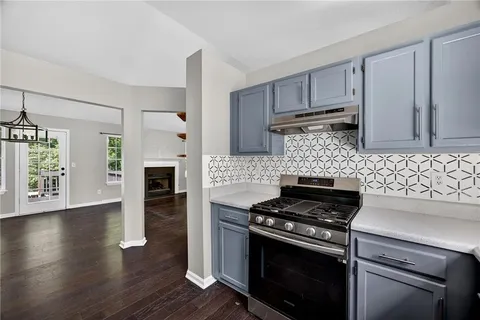 a kitchen with wooden floors and appliances