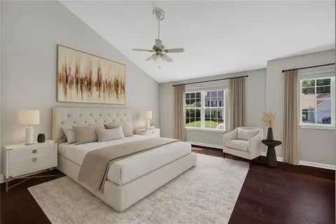 a spacious bedroom with a large bed and a couch