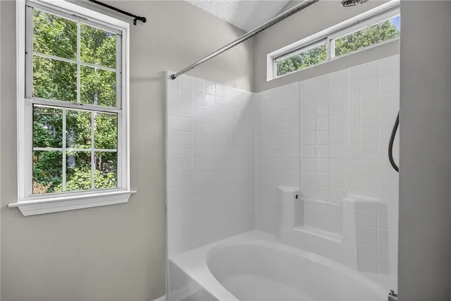 a bathroom with a bathtub and a shower