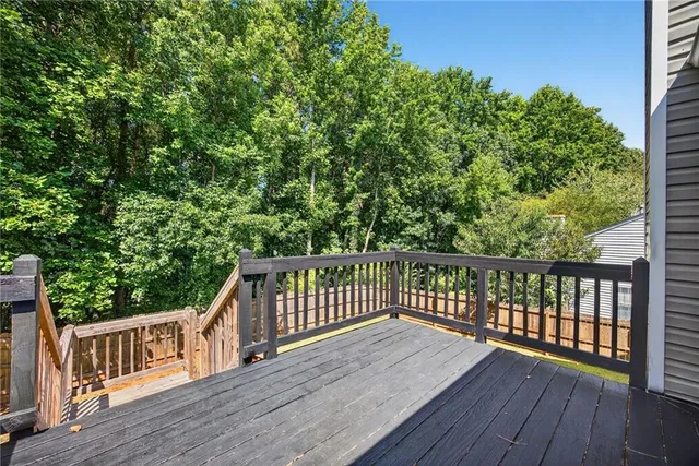 a view of balcony with wooden floor and fence