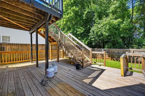 a view of balcony with wooden floor and fence