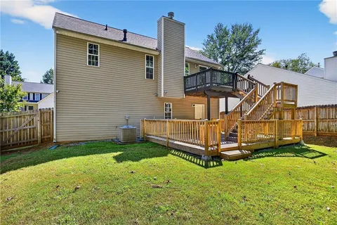 a view of a house with a yard and furniture