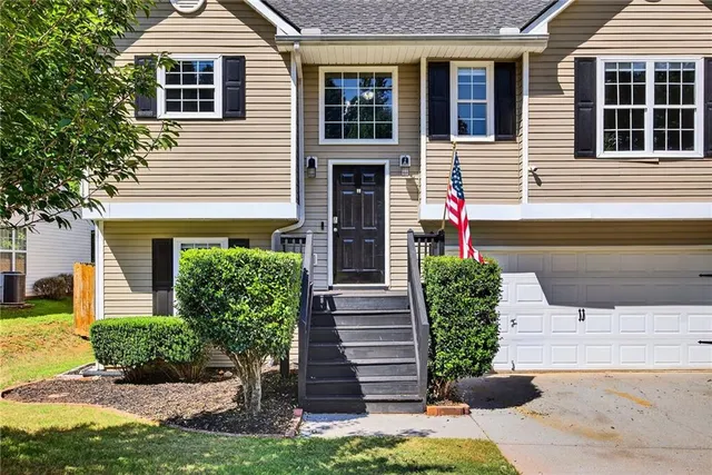 a front view of a house with garden