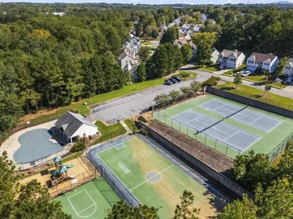an aerial view of a house with a yard