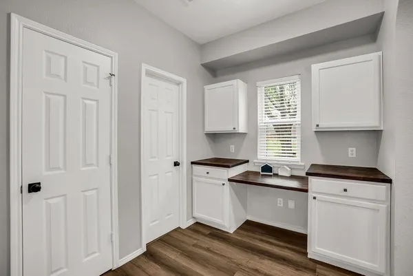 a kitchen with granite countertop a sink cabinets and window