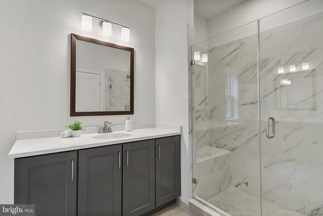 a bathroom with a double vanity sink mirror and shower