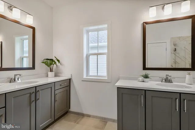 a bathroom with a double vanity sink and a mirror
