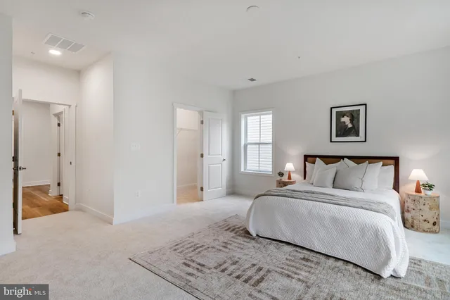 a bedroom with a bed and a lamp