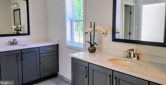 a bathroom with a sink vanity and a mirror