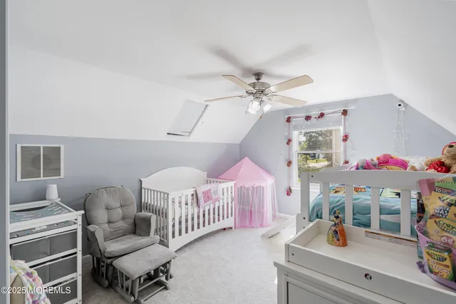 a bedroom with furniture and a baby crib