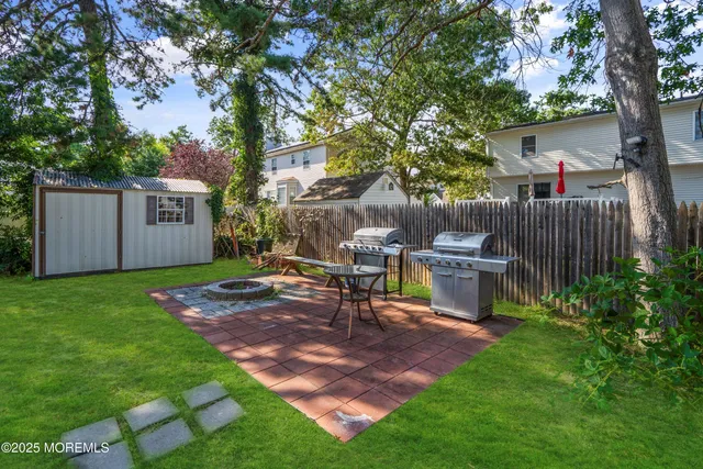 a view of a chair and table in backyard of house