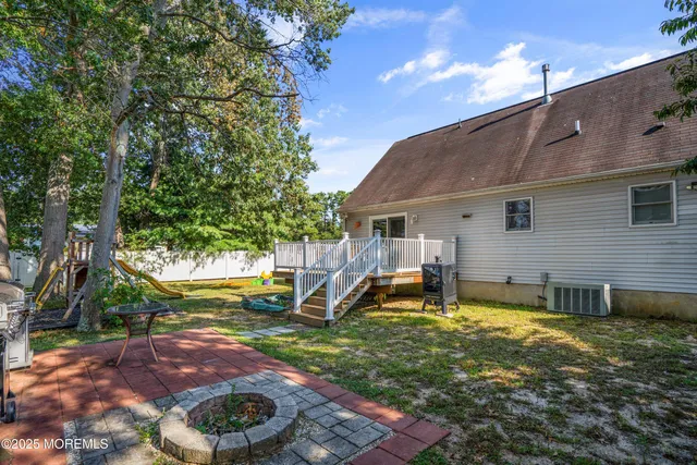 a backyard of a house with barbeque oven table and chairs