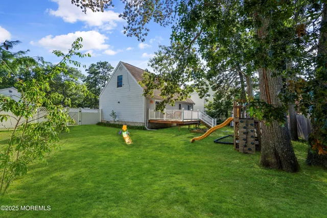 a view of a house with a park and a tree