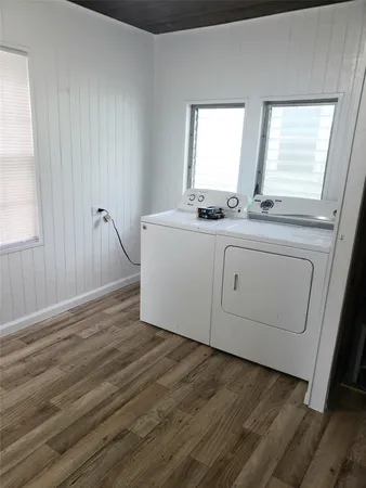 a room with wooden floors and sink