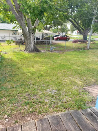 a swimming pool with outdoor seating and yard