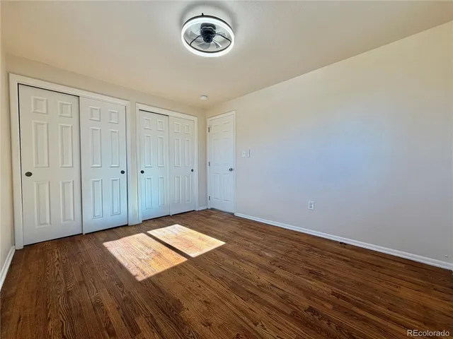 a view of a room with wooden floor