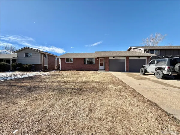 a view of a house with a snow in the yard