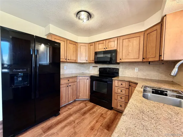 a kitchen with a refrigerator stove and sink