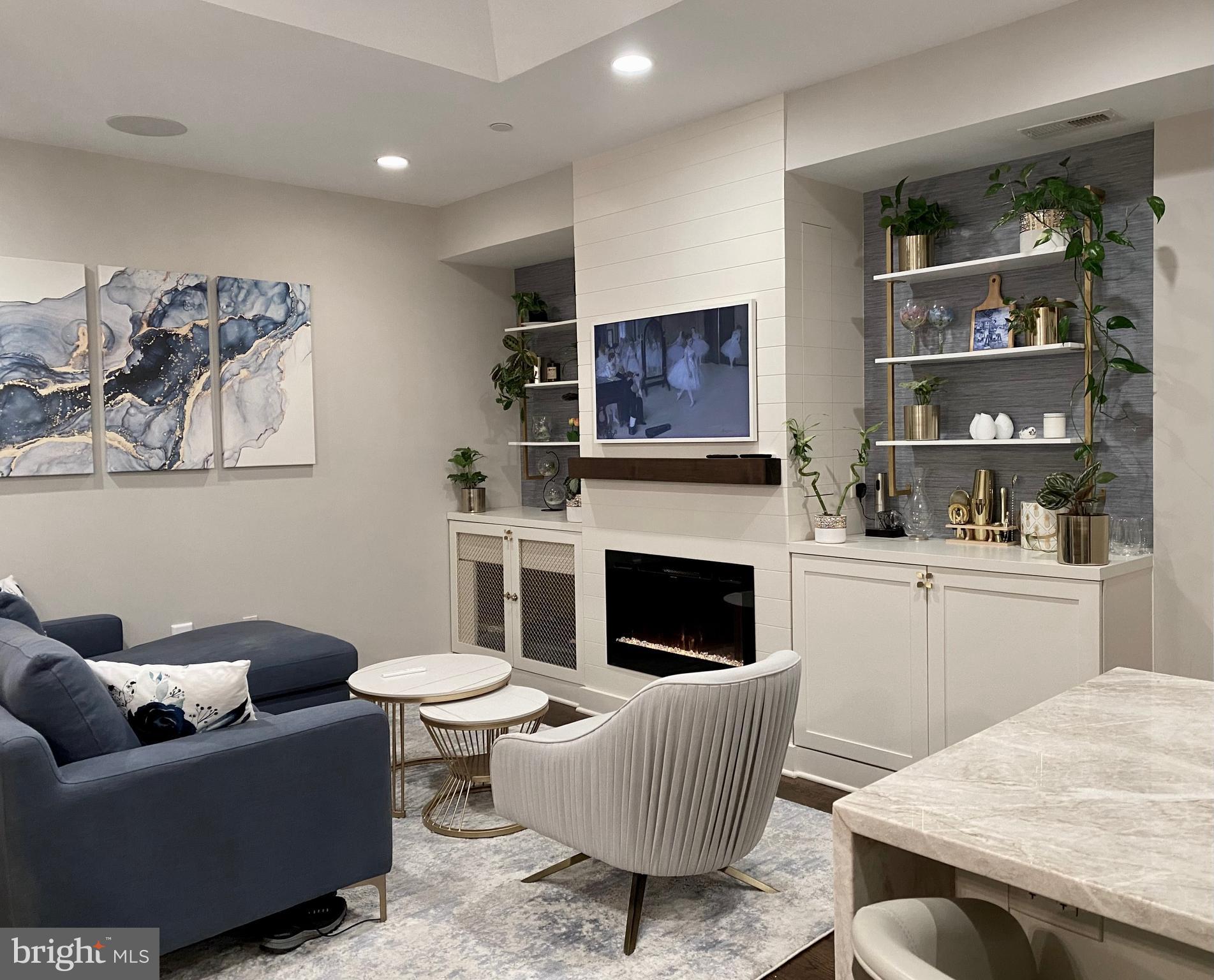 711 Jackson Street Northeast, Unit 3 Washington, DC 20017 - Photo 1 of 17 a living room with furniture a flat screen tv and a fireplace