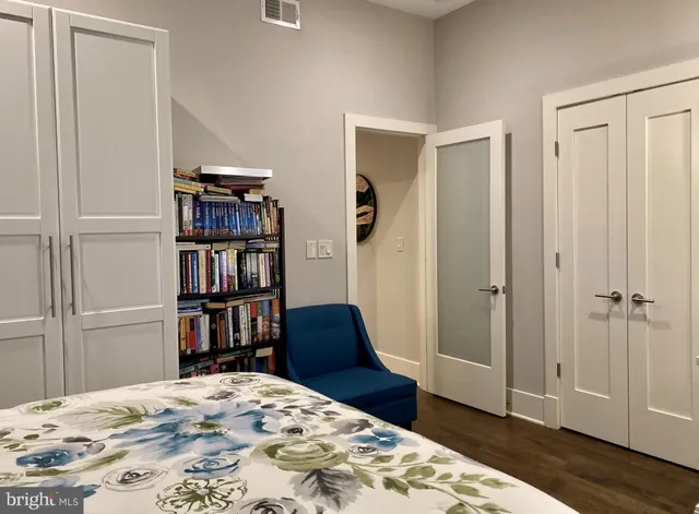 a bedroom with a bed and a book shelf
