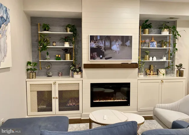 a living room with furniture and a fireplace