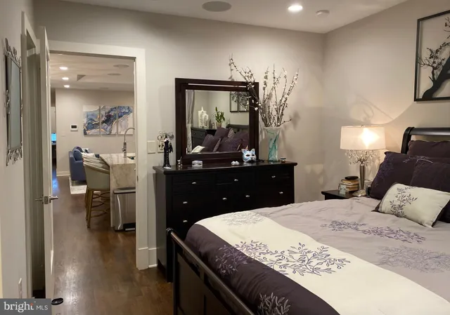 a bedroom with a large bed and a dresser