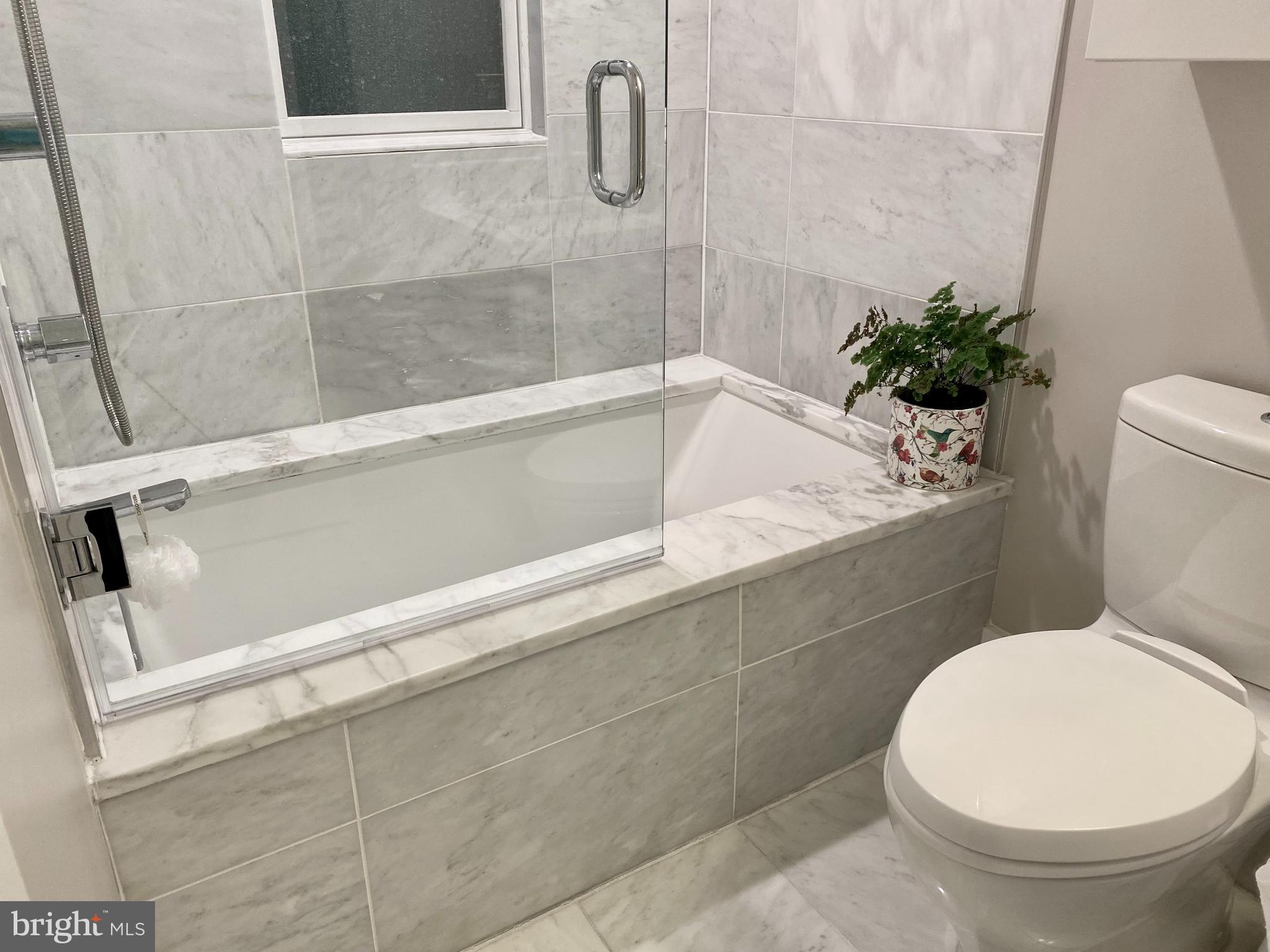 711 Jackson Street Northeast, Unit 3 Washington, DC 20017 - Photo 8 of 17 a bathroom with a toilet and a shower