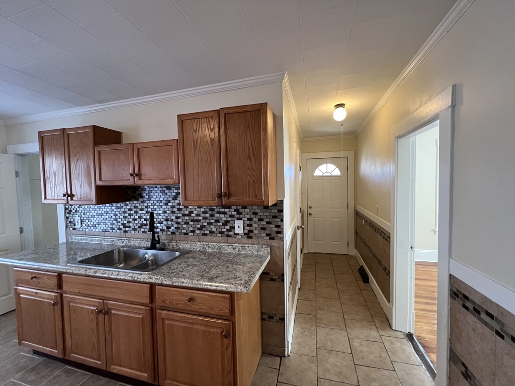75-77 Healey Street Springfield, MA 01151 - Photo 11 of 28 a kitchen with kitchen island granite countertop a sink and refrigerator