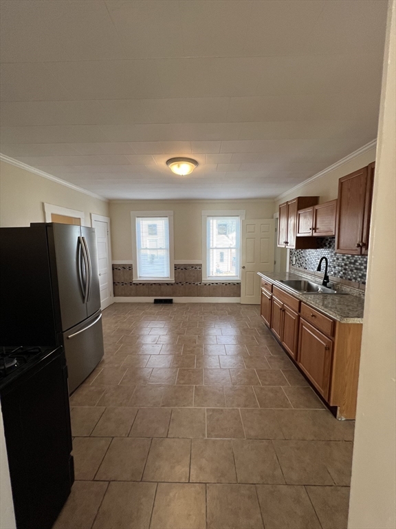 75-77 Healey Street Springfield, MA 01151 - Photo 12 of 28 a large kitchen with a stove a refrigerator and a dishwasher