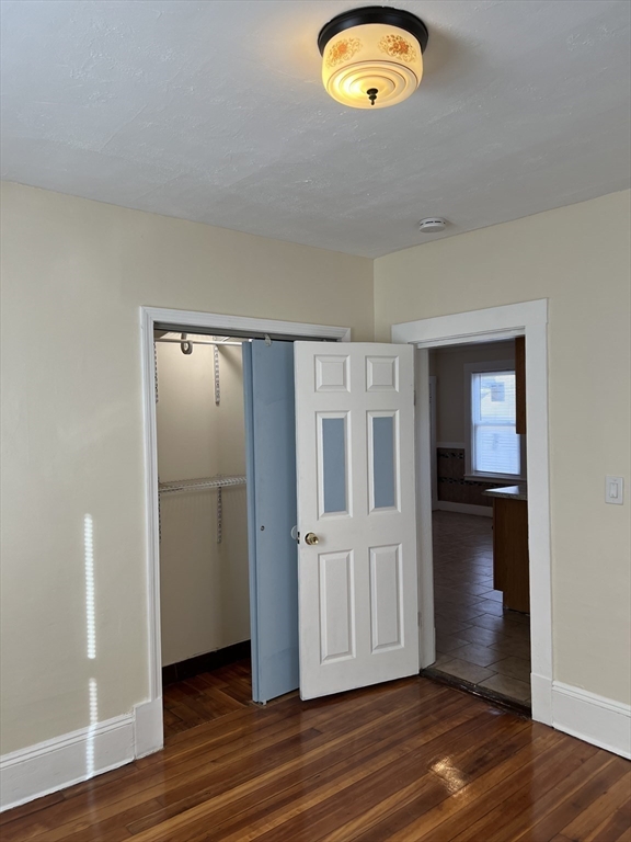 75-77 Healey Street Springfield, MA 01151 - Photo 17 of 28 an empty room with wooden floor and windows