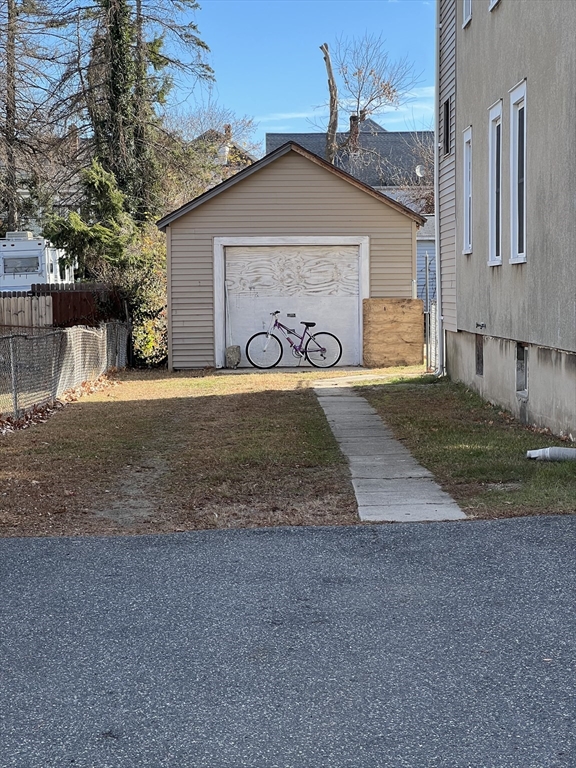 75-77 Healey Street Springfield, MA 01151 - Photo 3 of 28 a front view of a house with a yard and garage