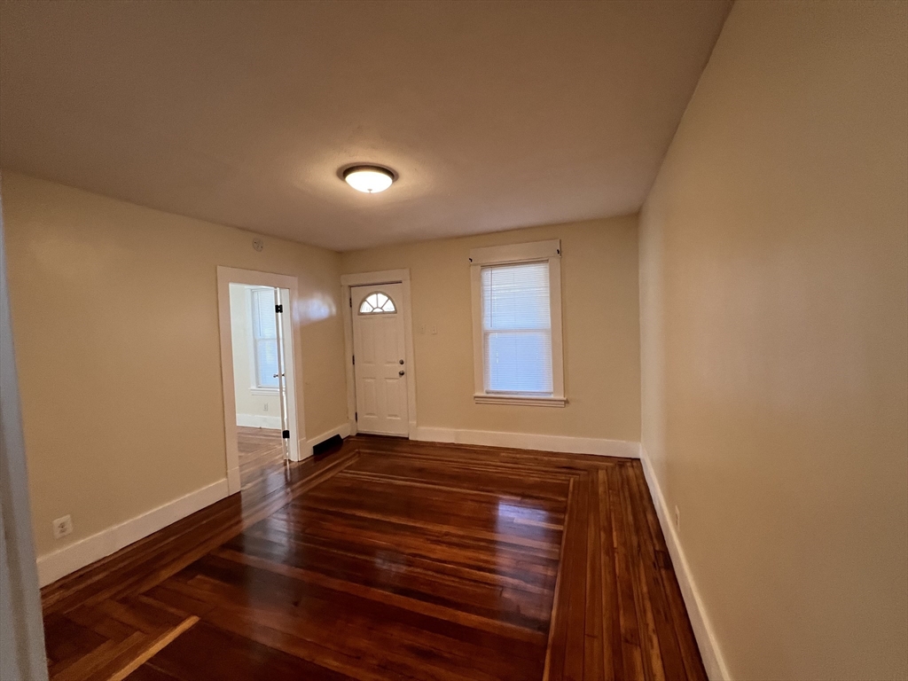 75-77 Healey Street Springfield, MA 01151 - Photo 5 of 28 a view of an empty room with window and wooden floor