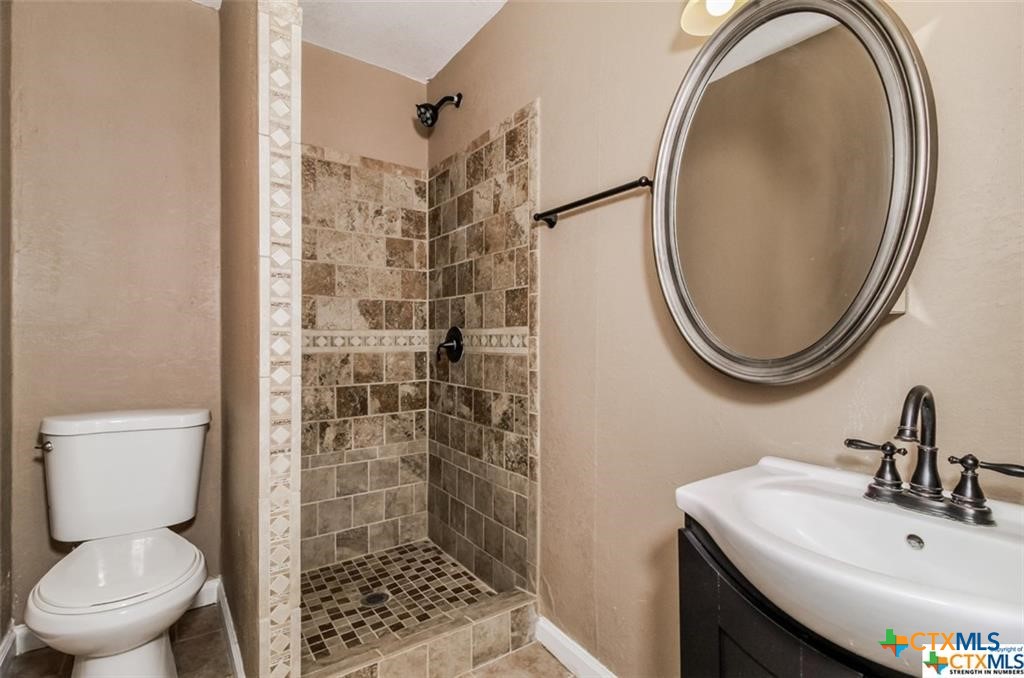4801 Renick Ranch Road Killeen, TX 76549 - Photo 11 of 29 a bathroom with a sink a toilet and a mirror