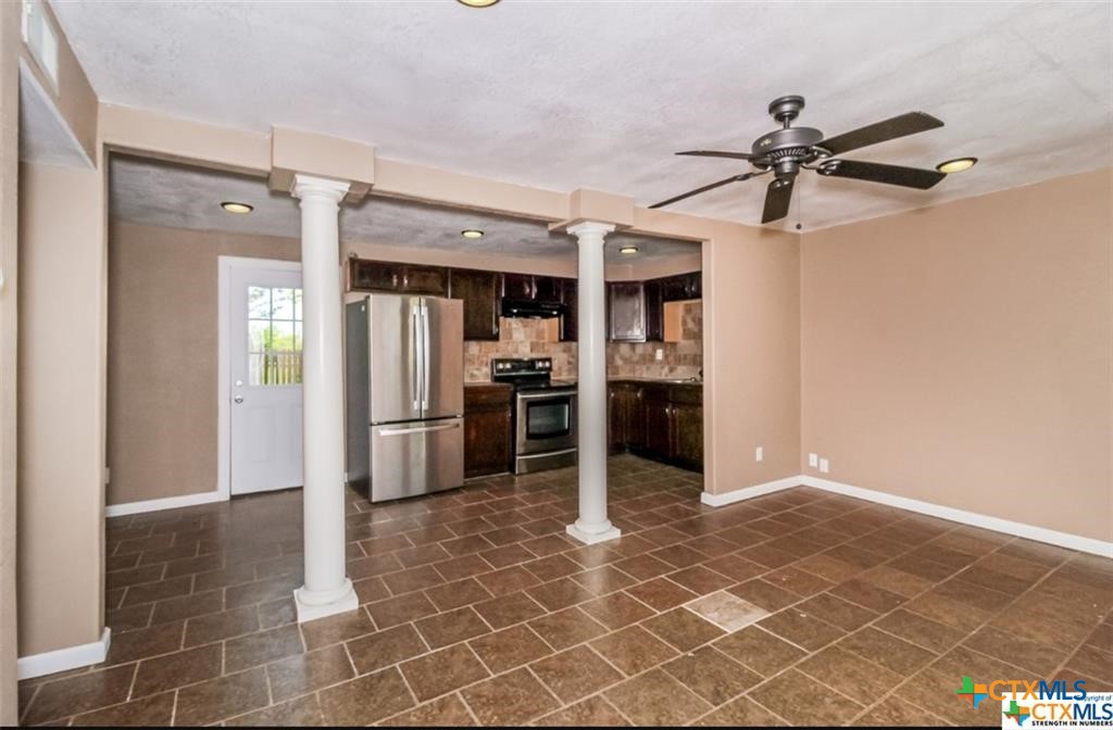 4801 Renick Ranch Road Killeen, TX 76549 - Photo 4 of 29 a kitchen with granite countertop a refrigerator and a sink