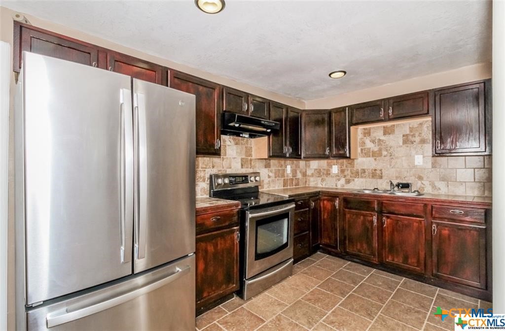 4801 Renick Ranch Road Killeen, TX 76549 - Photo 5 of 29 a kitchen with stainless steel appliances granite countertop a refrigerator stove and sink