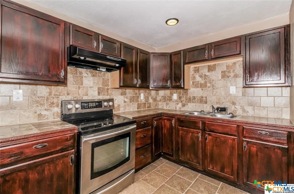 4801 Renick Ranch Road Killeen, TX 76549 - Photo 8 of 29 a kitchen with stainless steel appliances a stove sink and cabinets