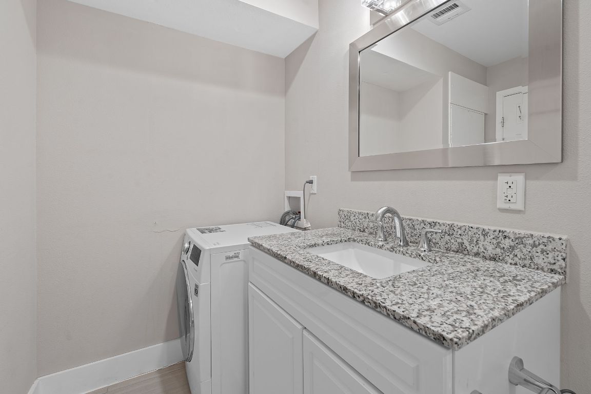 935 La Posada Drive, Unit 254 Austin, TX 78752 - Photo 12 of 19 Bathroom with baseboards and vanity