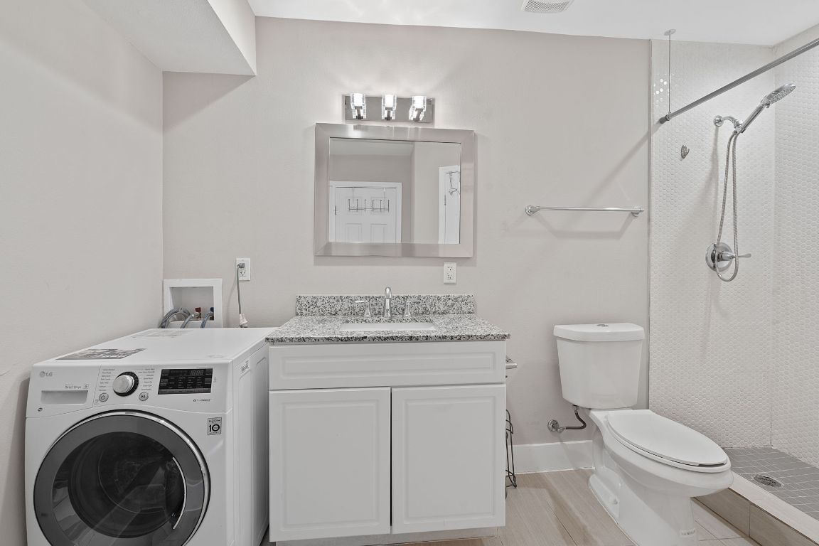 935 La Posada Drive, Unit 254 Austin, TX 78752 - Photo 14 of 19 Laundry room featuring washer / dryer and a sink