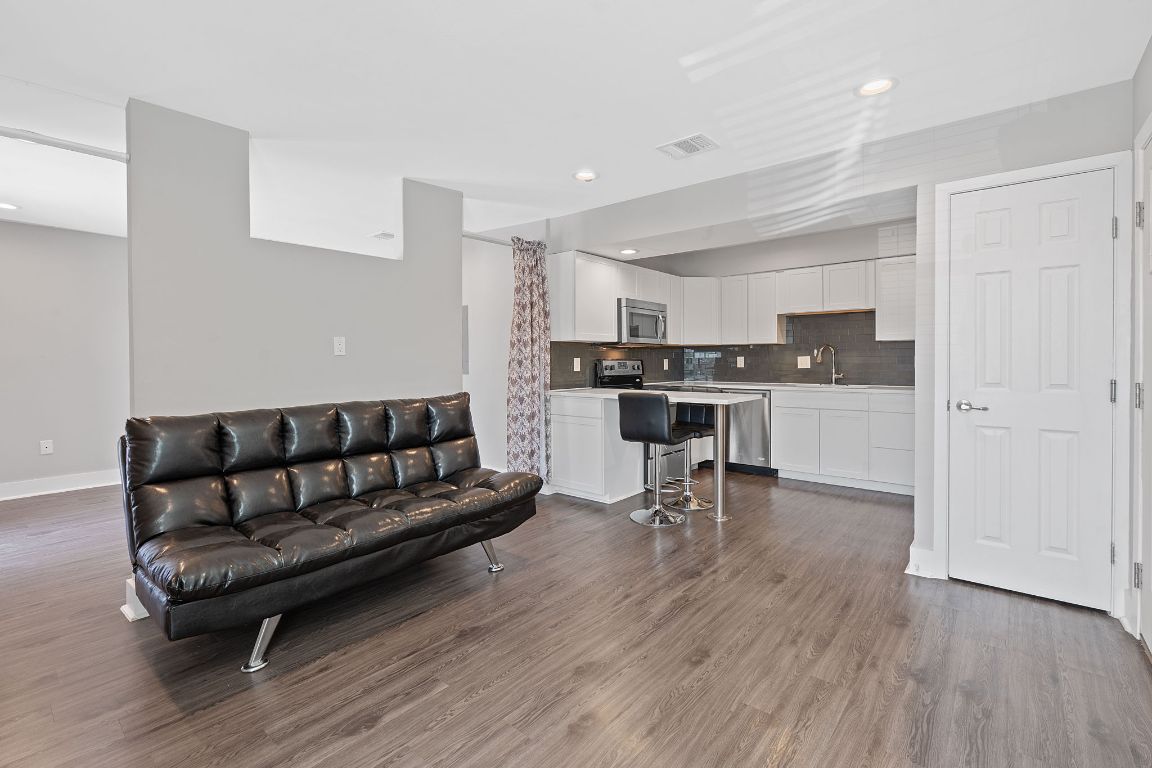 935 La Posada Drive, Unit 254 Austin, TX 78752 - Photo 5 of 19 Living room featuring dark wood finished floors and recessed lighting