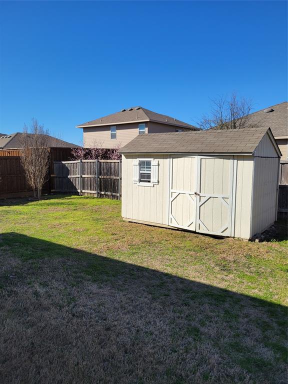 1633 Kawati Way Krum, TX 76249 - Photo 17 of 17 a view of a blue house with a yard