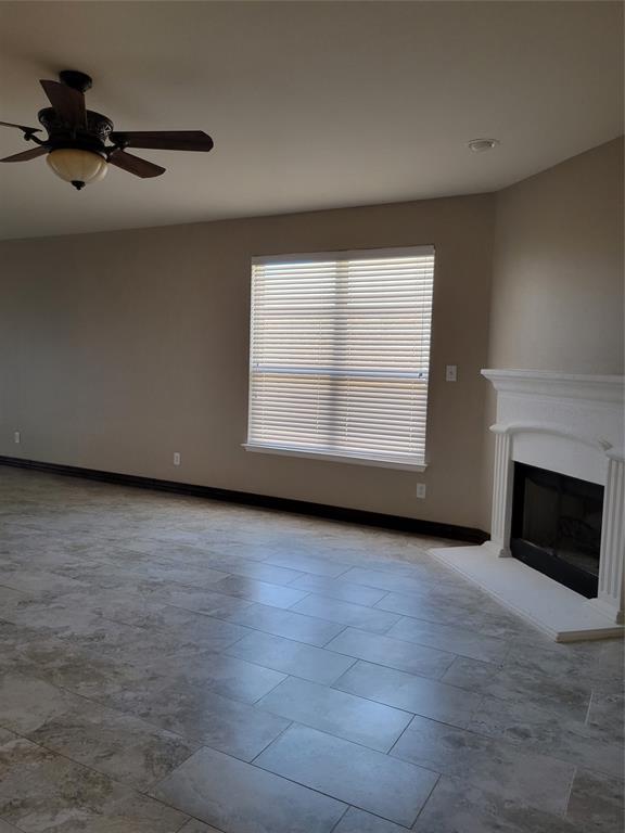 1633 Kawati Way Krum, TX 76249 - Photo 4 of 17 en empty room with windows and fireplace