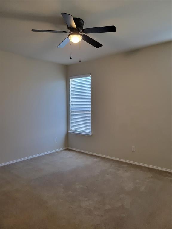 1633 Kawati Way Krum, TX 76249 - Photo 10 of 17 an empty room with a ceiling fan and a window