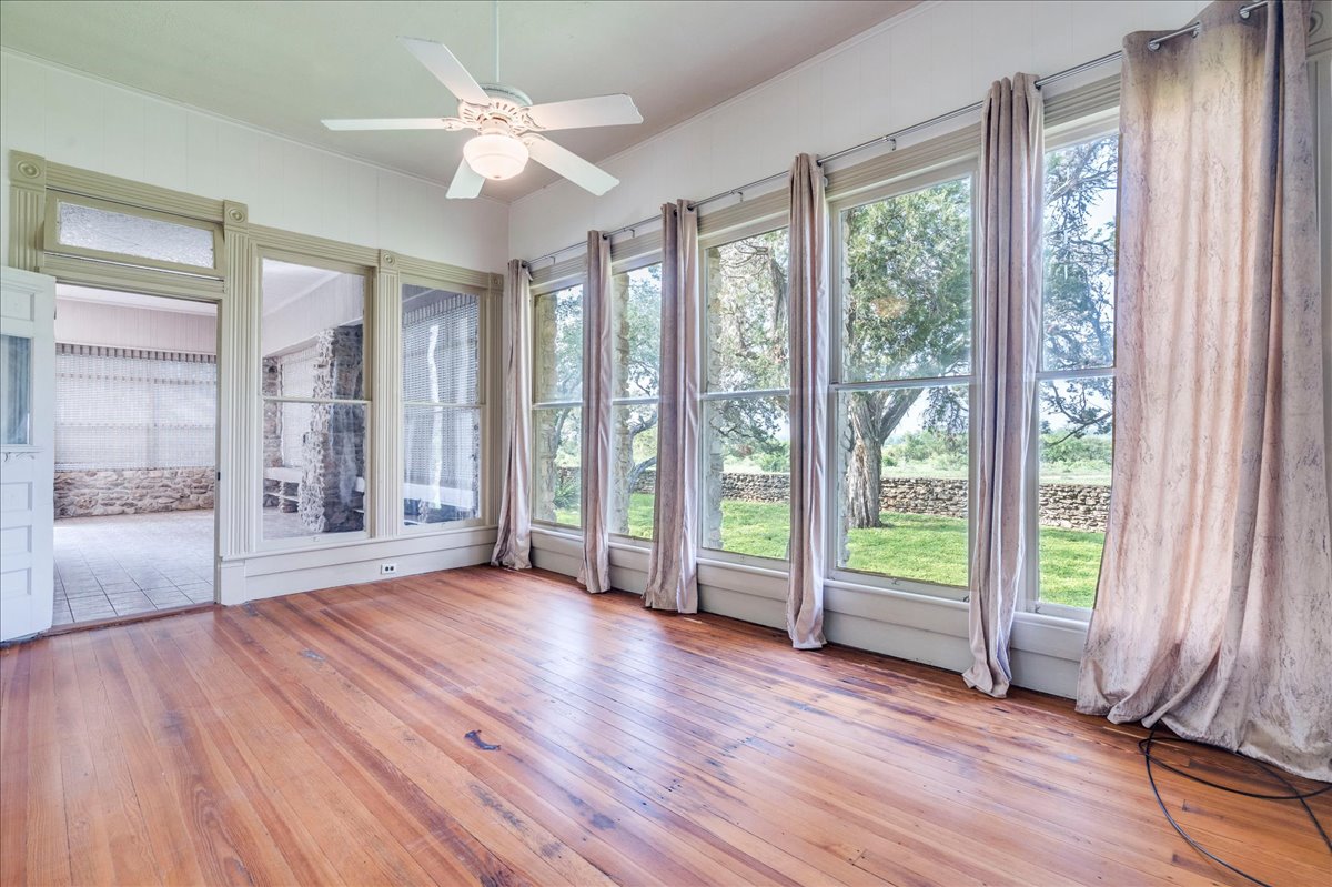 6400 Cypress Road Kyle, TX 78640 - Photo 18 of 33 Sunroom with wood flooring and a ceiling fan