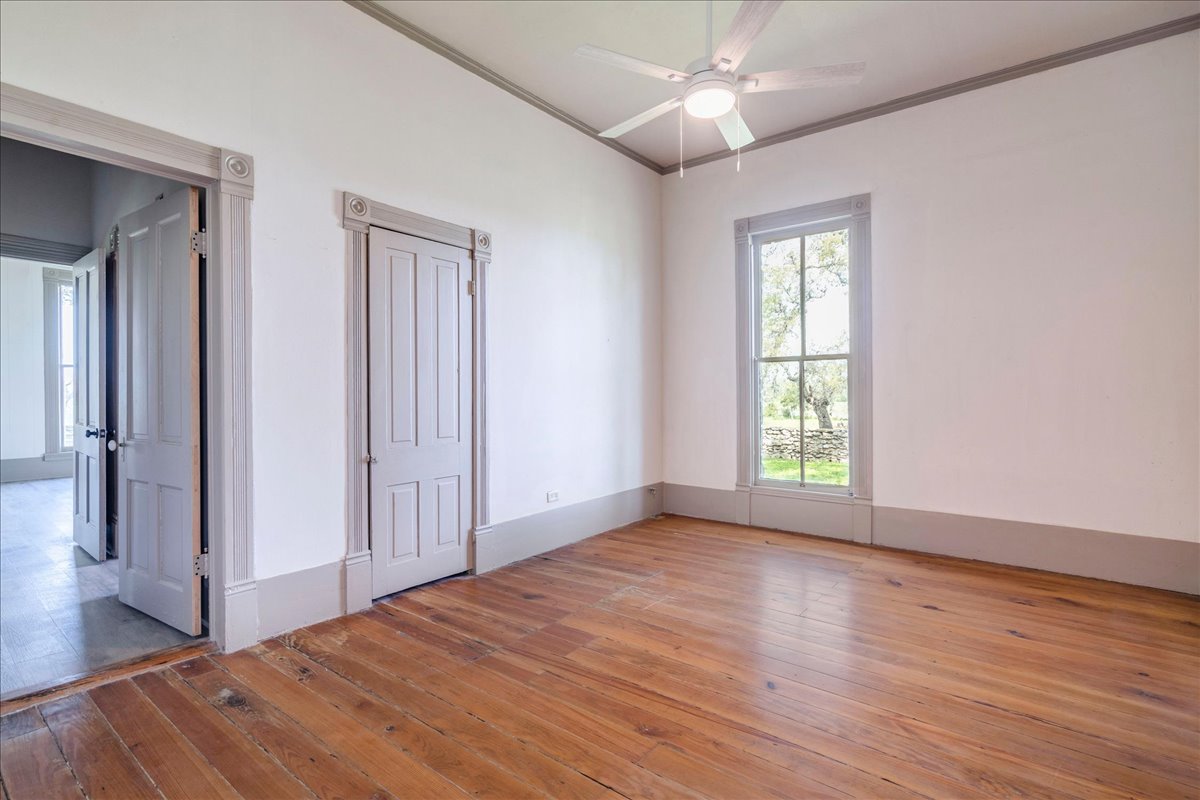 6400 Cypress Road Kyle, TX 78640 - Photo 22 of 33 Hardwood flooring and white walls with contrasting trim create a neutral palette