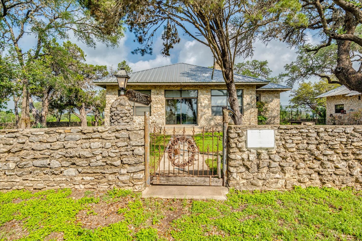 6400 Cypress Road Kyle, TX 78640 - Photo 4 of 33 Stone exterior residence featuring a metal roof